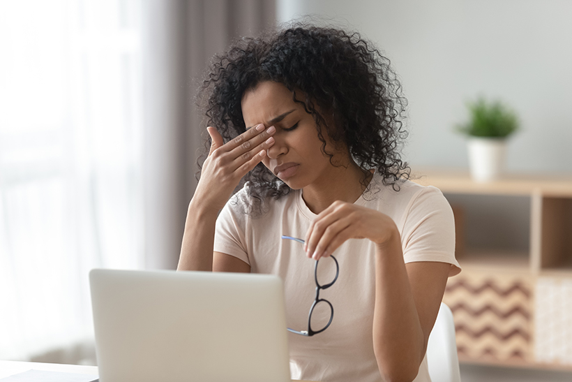 Tired woman with Computer Vision Syndrome