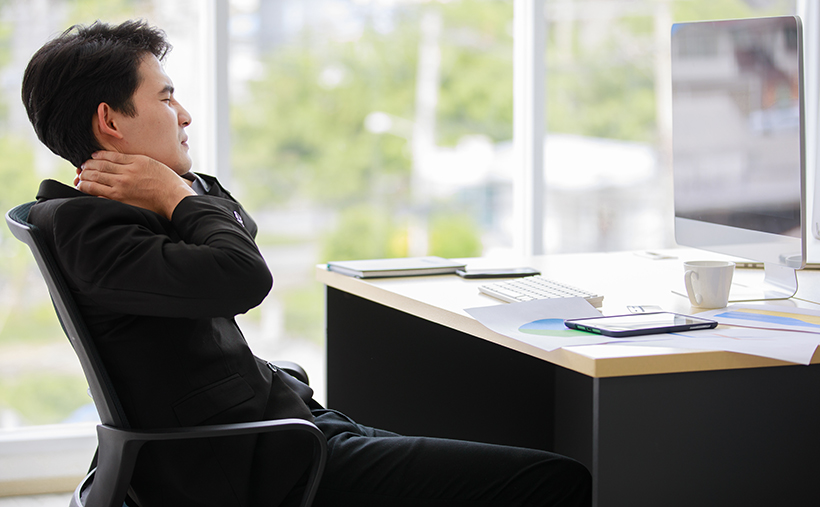 Man with aching neck from computer vision syndrome